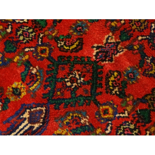 1316 - Carpet / Rug : A North West Persian Hamadan carpet the red ground decorated with cream vignette with... 