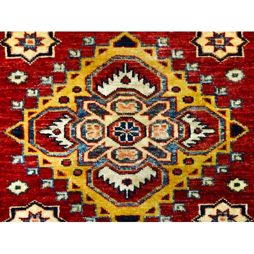 1317 - Carpet / Rug : A red ground runner decorated with repeating geometric motifs within banded geometric... 