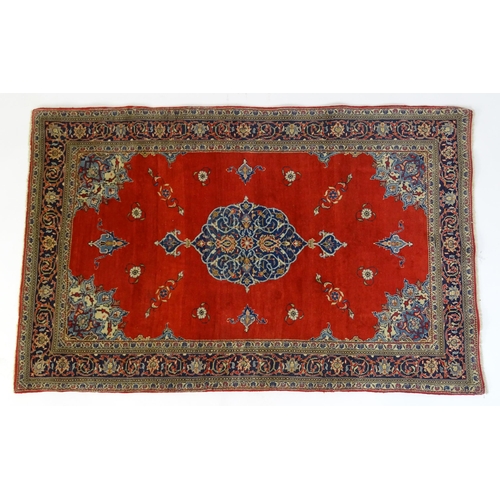 1312 - Carpet / Rug : A Central Persian Kashan rug, the red ground with central blue ground vignette, decor... 