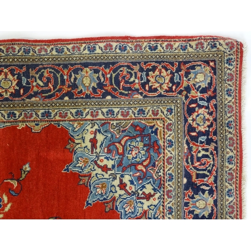 1312 - Carpet / Rug : A Central Persian Kashan rug, the red ground with central blue ground vignette, decor... 