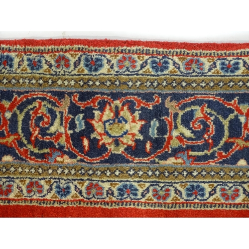 1312 - Carpet / Rug : A Central Persian Kashan rug, the red ground with central blue ground vignette, decor... 