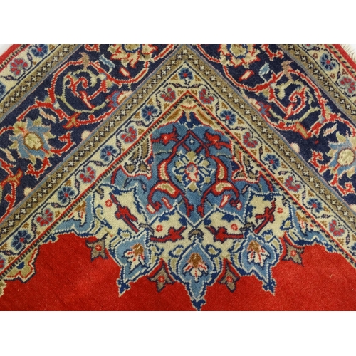 1312 - Carpet / Rug : A Central Persian Kashan rug, the red ground with central blue ground vignette, decor... 