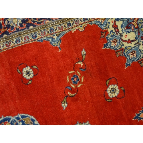 1312 - Carpet / Rug : A Central Persian Kashan rug, the red ground with central blue ground vignette, decor... 