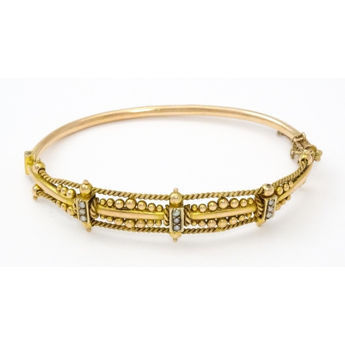 591 - A Victorian 9ct gold bracelet of bangle form set with seed pearls (Approx. 7.5g)