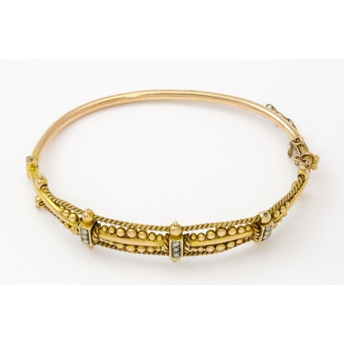 591 - A Victorian 9ct gold bracelet of bangle form set with seed pearls (Approx. 7.5g)