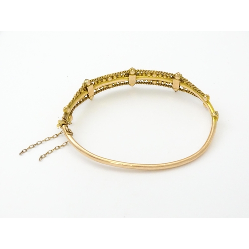 591 - A Victorian 9ct gold bracelet of bangle form set with seed pearls (Approx. 7.5g)