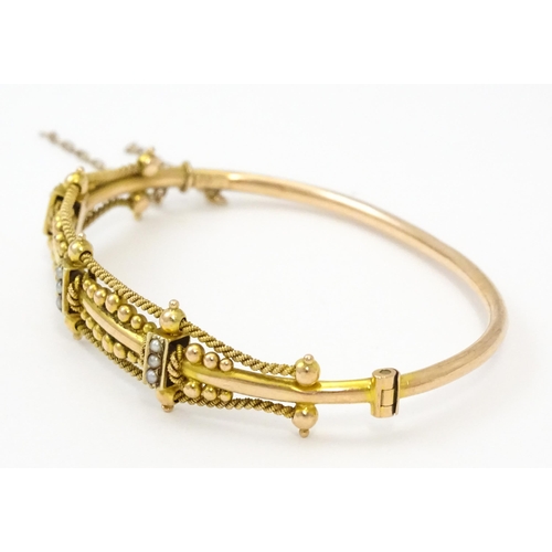 591 - A Victorian 9ct gold bracelet of bangle form set with seed pearls (Approx. 7.5g)