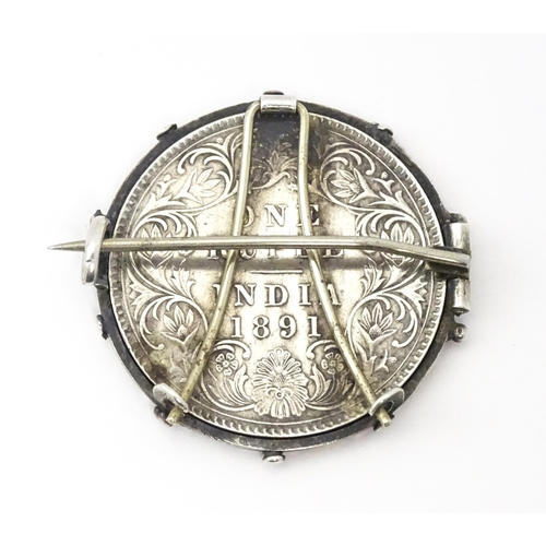 709 - A white metal brooch set with central Victorian Indian one rupee coin. Approx. 1 1/4