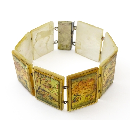 734 - An Indian bracelet with mother of pearl panels decorated  with scenes depicting figures, birds etc.