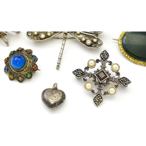 737 - Five assorted brooches to include some two silver examples, and a heart shaped silver locket. (6)