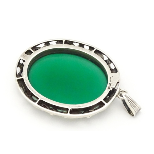 746 - A silver pendant set with green cabochon. Approx. 1 3/4