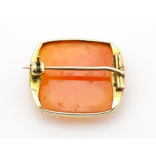 750 - A brooch set with orange carnelian within a yellow metal mount.  Approx. 1