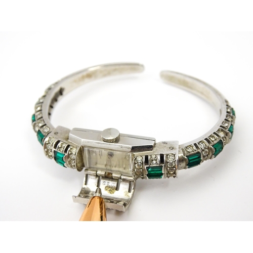 808 - A Swiss bangle formed cocktail watch set with white and green stones, the central section  hinging o... 