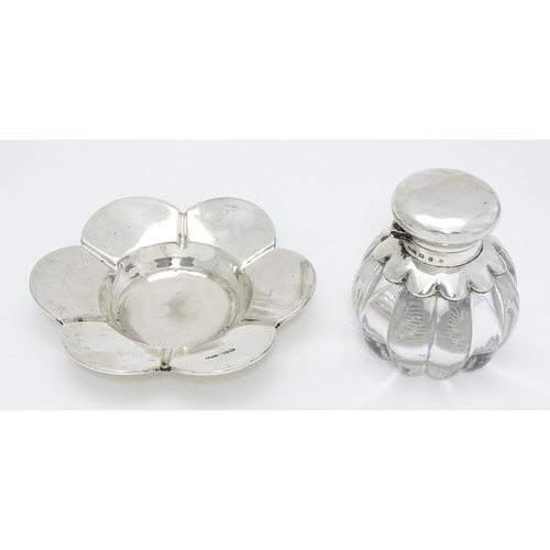 248 - A Victorian glass inkwell of lobed form with silver mounts and silver stand of flower form, hallmark... 