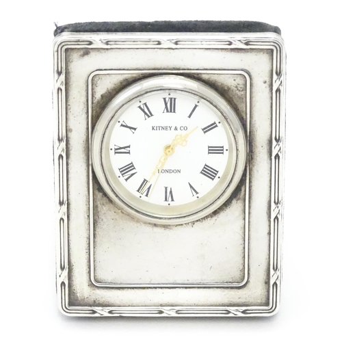 251 - A easel back clock with silver surround hallmarked London 1994 maker Kitney & Co. Approx 2 3/4