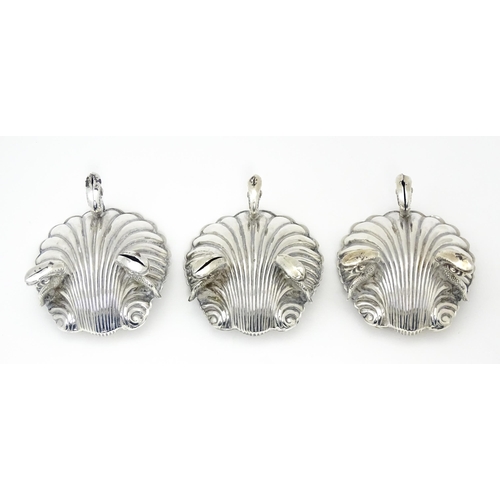 262 - Three Victorian silver salts of scallop shell form raised on three stylised dolphin feet, hallmarked... 