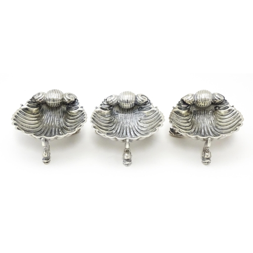 262 - Three Victorian silver salts of scallop shell form raised on three stylised dolphin feet, hallmarked... 