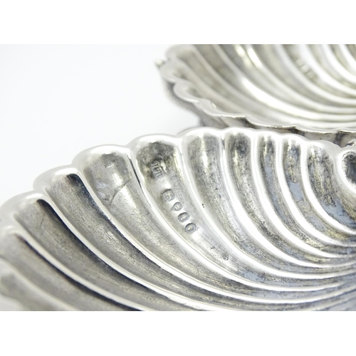 262 - Three Victorian silver salts of scallop shell form raised on three stylised dolphin feet, hallmarked... 