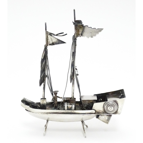 265 - An Oriental silver model of a boat. Marked sterling with Oriental character marks and stamped HKPP. ... 