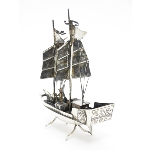 265 - An Oriental silver model of a boat. Marked sterling with Oriental character marks and stamped HKPP. ... 