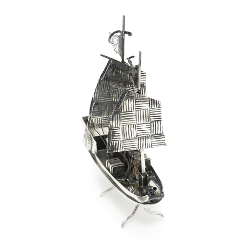 265 - An Oriental silver model of a boat. Marked sterling with Oriental character marks and stamped HKPP. ... 