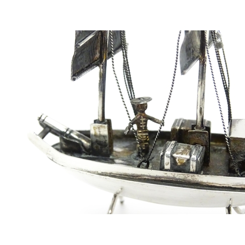 265 - An Oriental silver model of a boat. Marked sterling with Oriental character marks and stamped HKPP. ... 