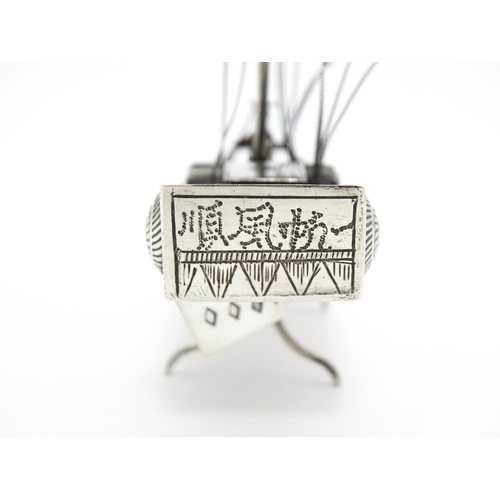 265 - An Oriental silver model of a boat. Marked sterling with Oriental character marks and stamped HKPP. ... 