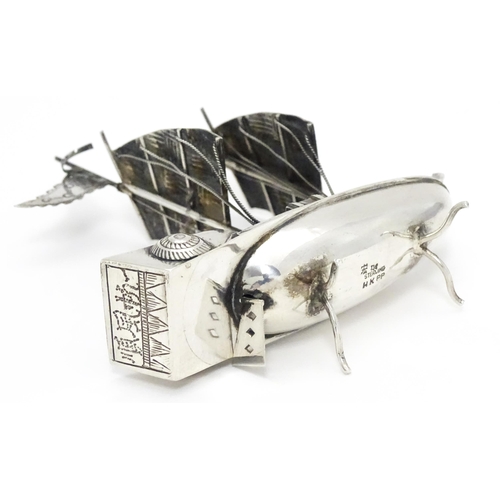 265 - An Oriental silver model of a boat. Marked sterling with Oriental character marks and stamped HKPP. ... 