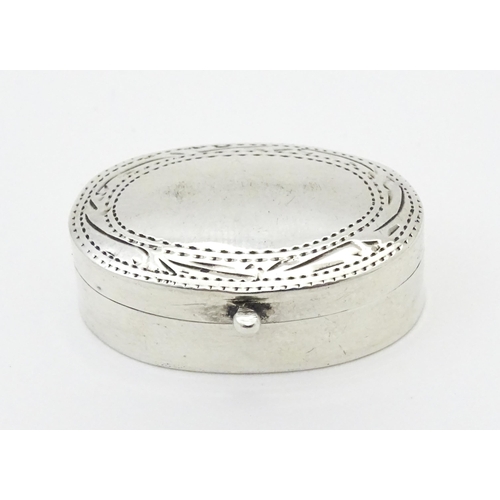 270 - A .925 silver pill box of oval form with engraved decoration and hinged lid. Approx 1 1/4