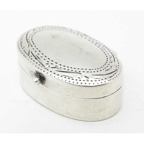 270 - A .925 silver pill box of oval form with engraved decoration and hinged lid. Approx 1 1/4