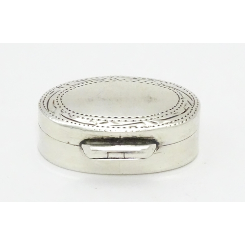 270 - A .925 silver pill box of oval form with engraved decoration and hinged lid. Approx 1 1/4