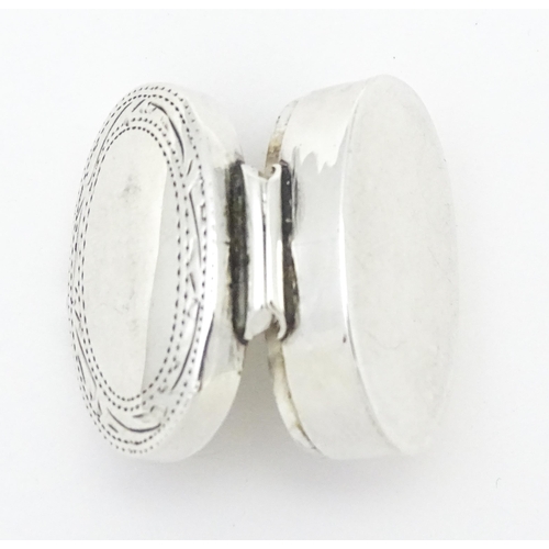 270 - A .925 silver pill box of oval form with engraved decoration and hinged lid. Approx 1 1/4