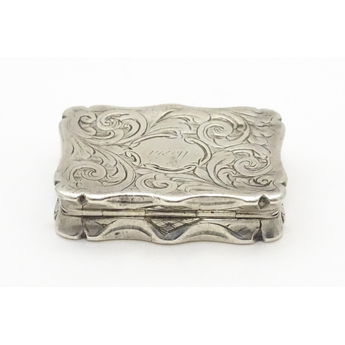 274 - A silver vinaigrette with acanthus scroll decoration. Hallmarked Birmingham 1845, maker Nathaniel Mi... 