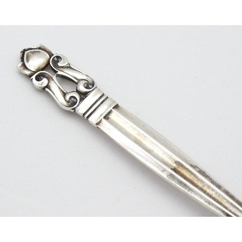 310 - A Georg Jensen silver teaspoon marked Sterling Denmark. Approx. 4 1/2