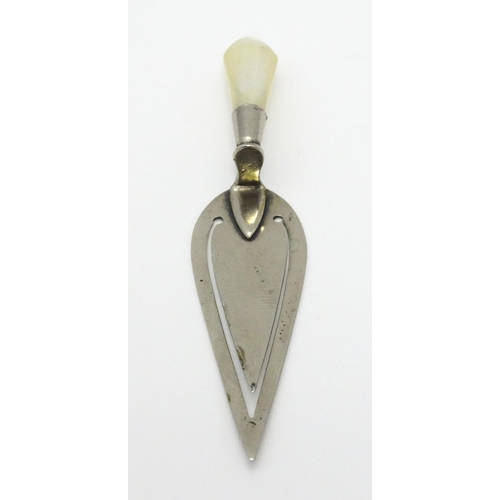 325 - A silver plate page marker formed as a stylised trowel with mother of pearl handle. Approx 3 1/2