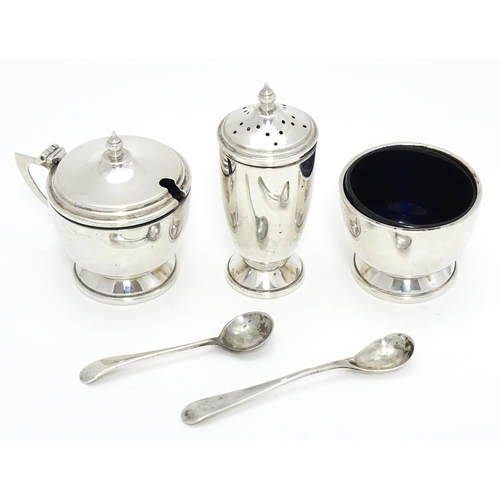 430 - A cased Art Deco style silver three piece cruet set comprising salt, pepper and mustard, hallmarked ... 