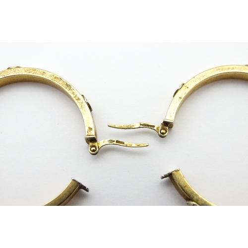 732 - A pair of 9ct gold hoop earrings. Approx. 1 1/4