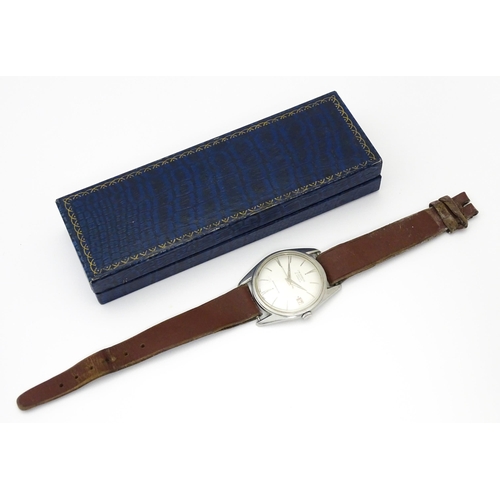 812 - A 1960s gentleman's wristwatch by J W Benson, the dial with hour batons and date aperture. With case... 