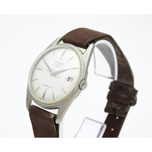 812 - A 1960s gentleman's wristwatch by J W Benson, the dial with hour batons and date aperture. With case... 