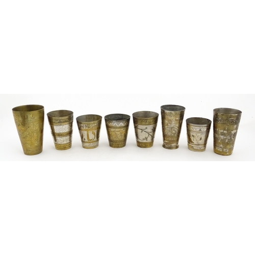 1047 - Eight assorted Indian brass lassi beakers / cups to include examples with silvered detail, and some ... 