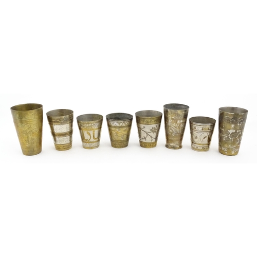 1047 - Eight assorted Indian brass lassi beakers / cups to include examples with silvered detail, and some ... 