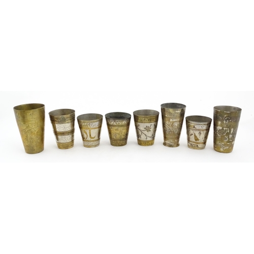 1047 - Eight assorted Indian brass lassi beakers / cups to include examples with silvered detail, and some ... 