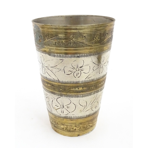 1047 - Eight assorted Indian brass lassi beakers / cups to include examples with silvered detail, and some ... 