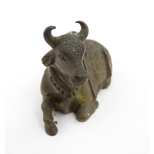 1049 - Three assorted items to include an Indian cast brass Nandi idol modelled as a recumbent bull with st... 