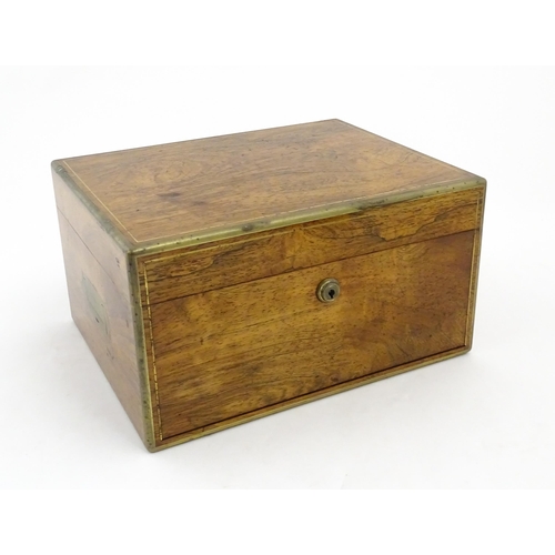 1066 - A Victorian walnut jewellery box / vanity case with inlaid brass stringing, campaign style handle an... 