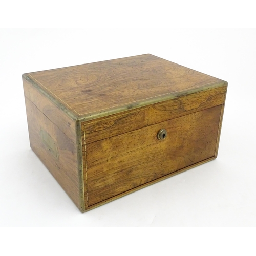 1066 - A Victorian walnut jewellery box / vanity case with inlaid brass stringing, campaign style handle an... 