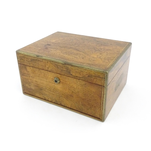 1066 - A Victorian walnut jewellery box / vanity case with inlaid brass stringing, campaign style handle an... 