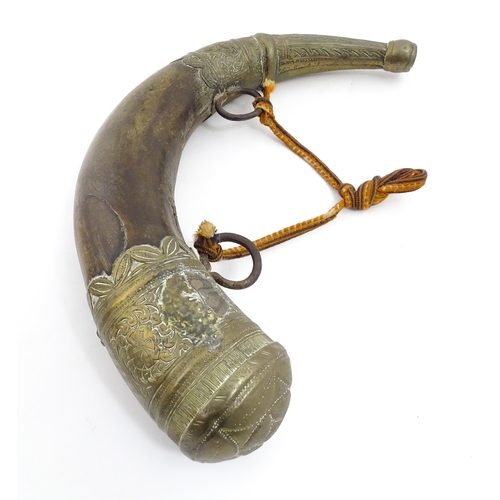 1070 - A 19thC Eastern powder flask, constructed from ox horn with decorative brass mounts and a weaved lan... 