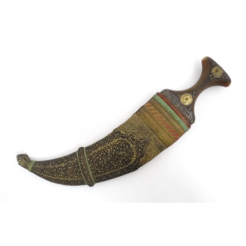 1071 - A 19thC Eastern Jambiya / Khanjar knife, the ram's horn hilt with two coins retaining the tang of th... 