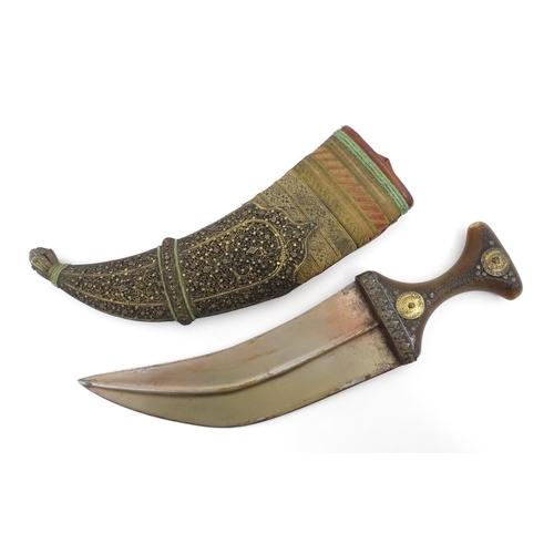 1071 - A 19thC Eastern Jambiya / Khanjar knife, the ram's horn hilt with two coins retaining the tang of th... 